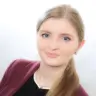 Bio image of Nataliia Luhyna in burgundy blazer