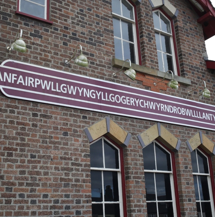 A sign on a railway station which shows off the 58 character longest name.
