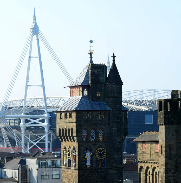 Views of a castle and sports and entertainment arena in a city centre.