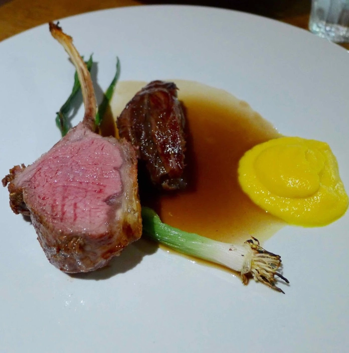 Welsh lamb dish with gravy and vegetables.