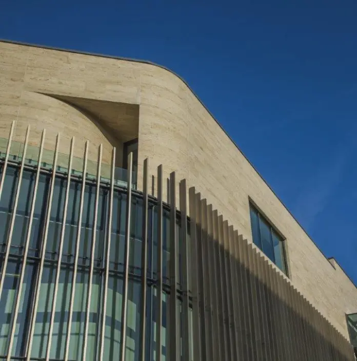 New Pontio building with concrete and large glass window panes against the older part of the university tower. 