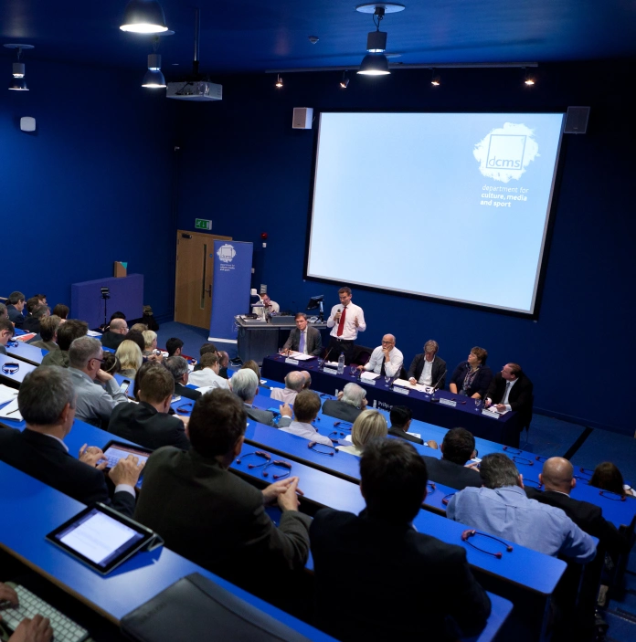A lecture being delivered at a theatre style conference room.