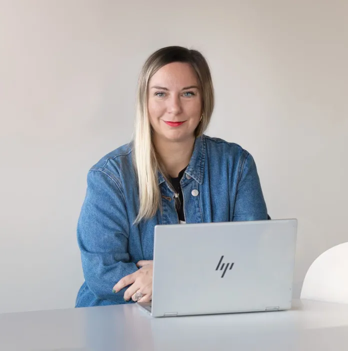 bio image of Sofia Christidi sitting at her laptop working