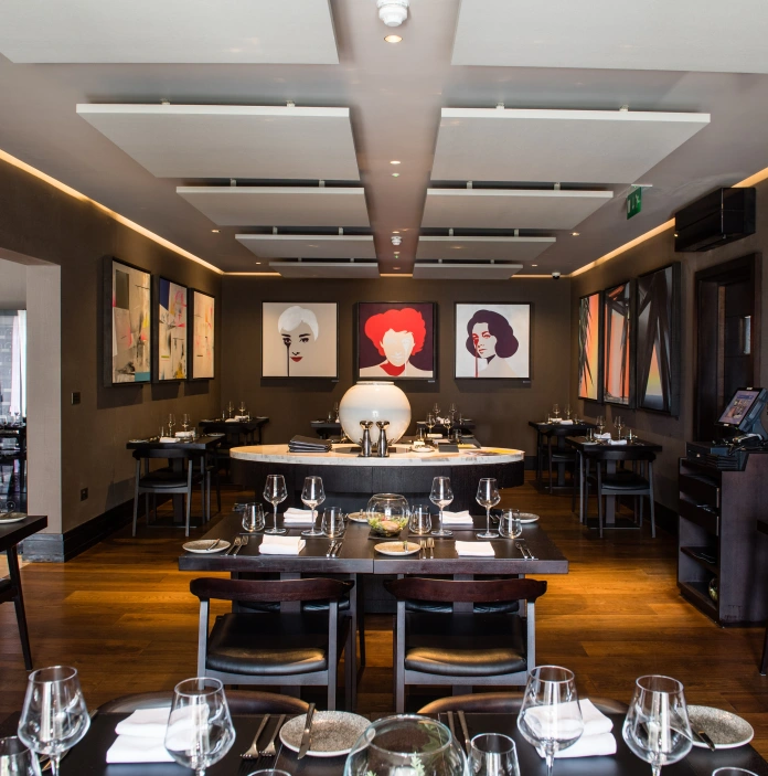 Tables and chairs inside the Twr y Felin restaurant Blas.