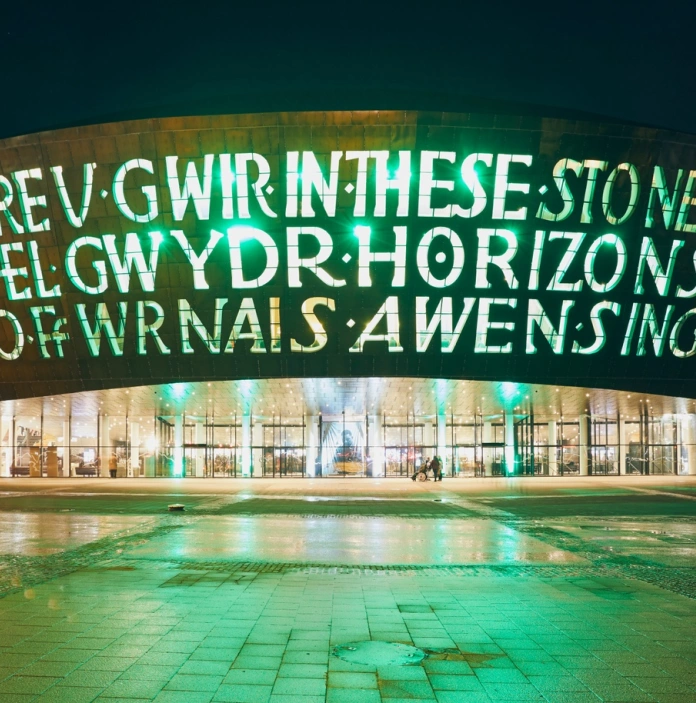 WMC building in the dark with the wording lit up in green