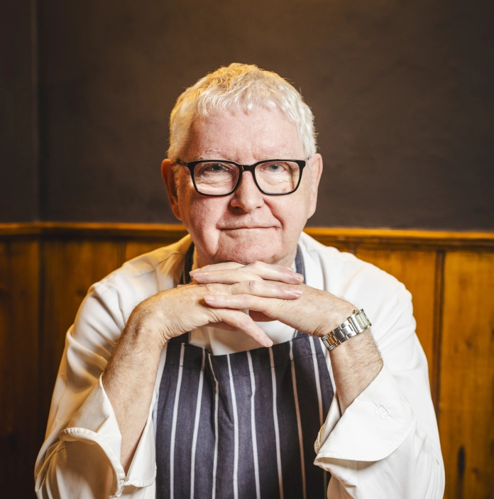 Chef's Chef, Shaun Hill, seated facing the camera with hands under his chin.