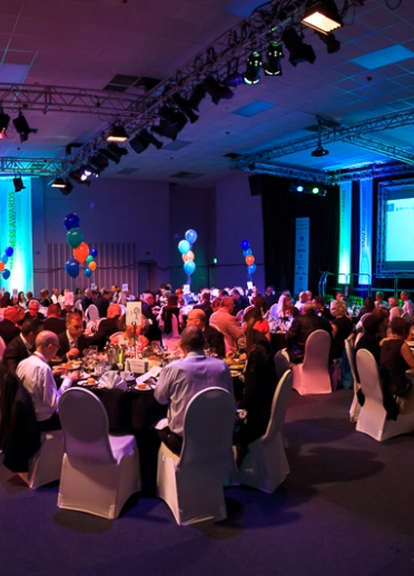 People sat down at tables at an awards evening.