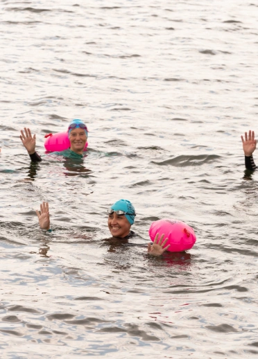 group of people wild water swimming in the reservoir