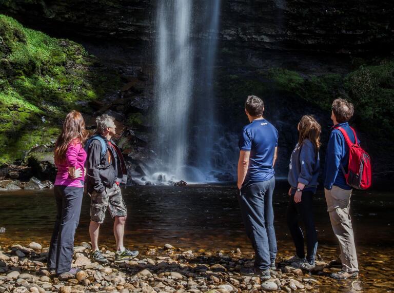 People looking at a waterfall.