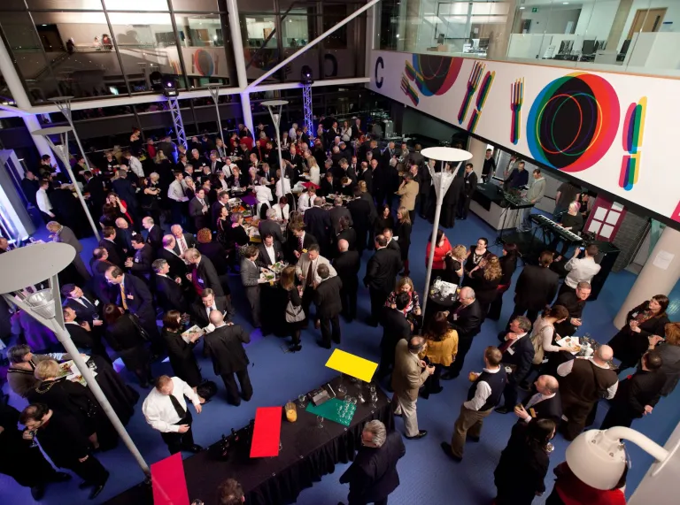 An overhead shot of lots of business people in a food court at a university.