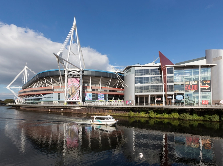 External view of a stadium alongside the water.