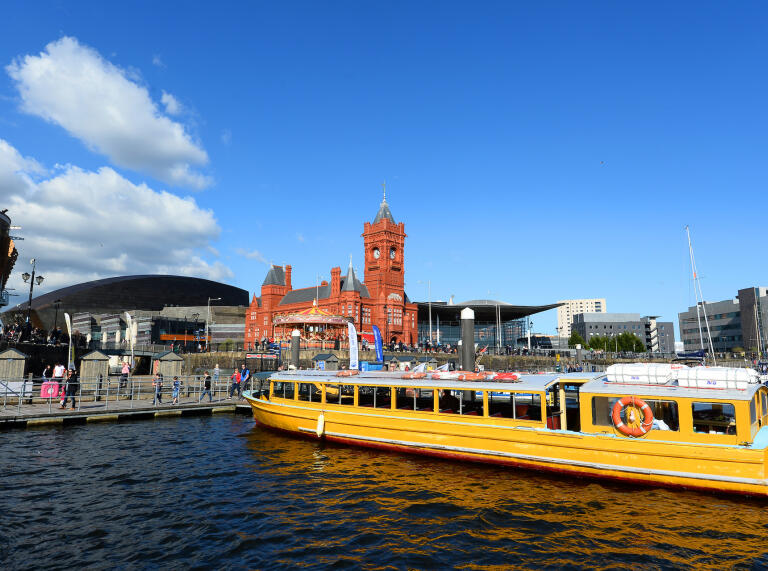 Cardiff Bay water taxi with Pierhead Building and WMC in background.