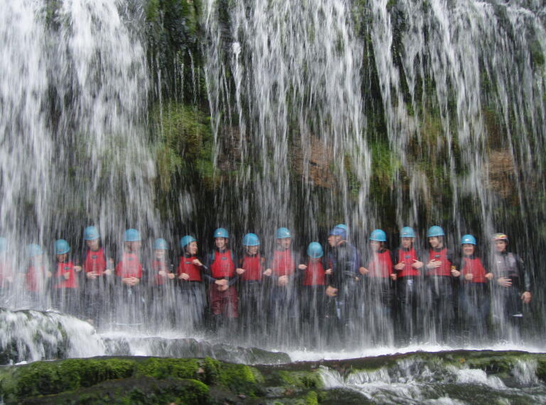 Group team building under waterfall