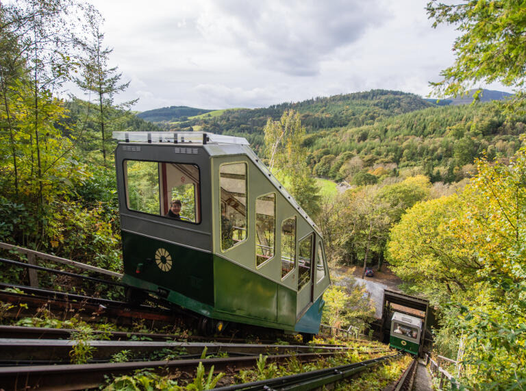 Carriages travelling on the funicular railway with views of the countryside.