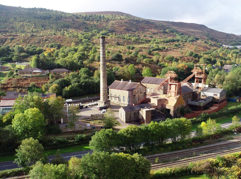 Distance view of Rhondda Heritage Park with hills in background.