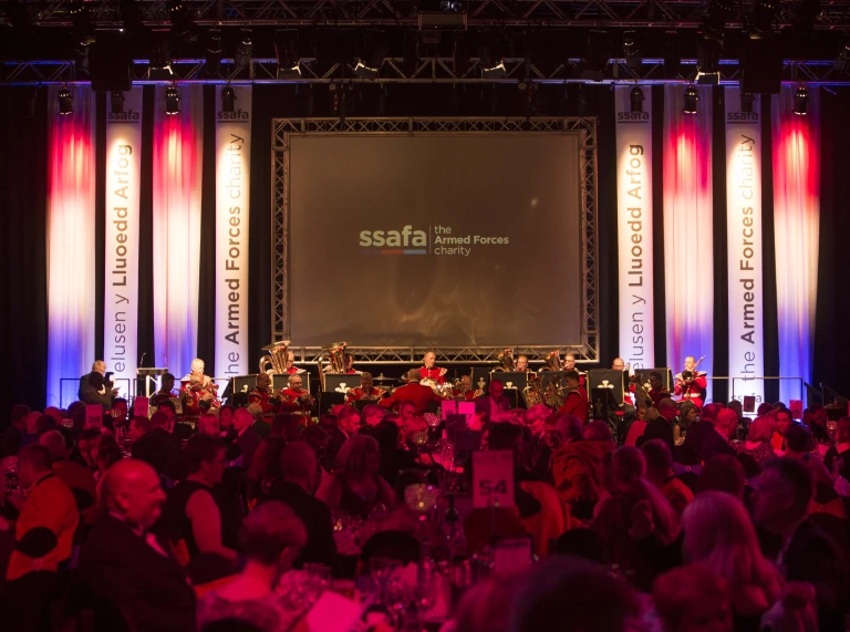 People sat at tables at a gala dinner.