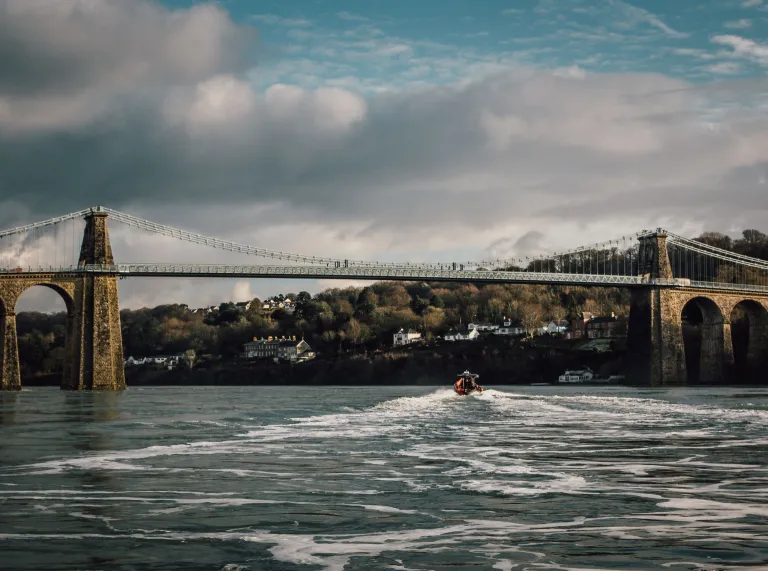 Ribride speed boat on the Menai Straight going under bridge.
