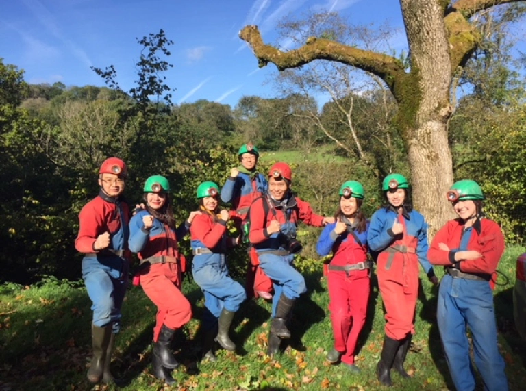 A group of people posing for a photo in safety gear.