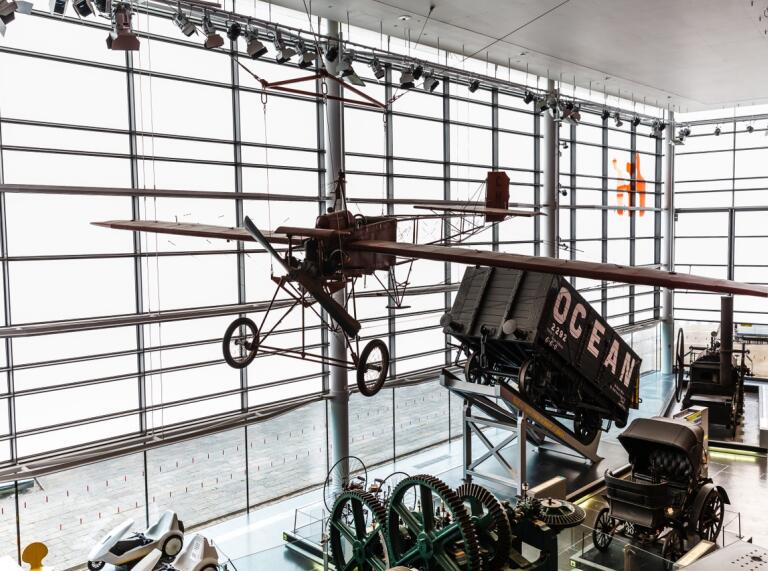 A plane hanging from the ceiling inside a museum.