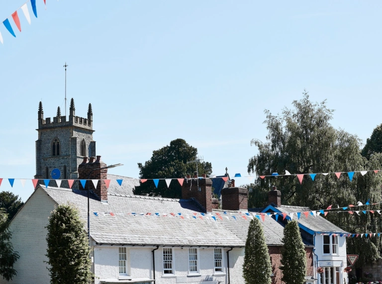 Bunting, church and white building.