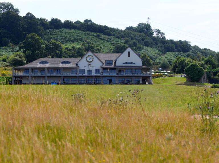 Twenty Ten Clubhouse at the Celtic Manor with green in front on a bright day. 