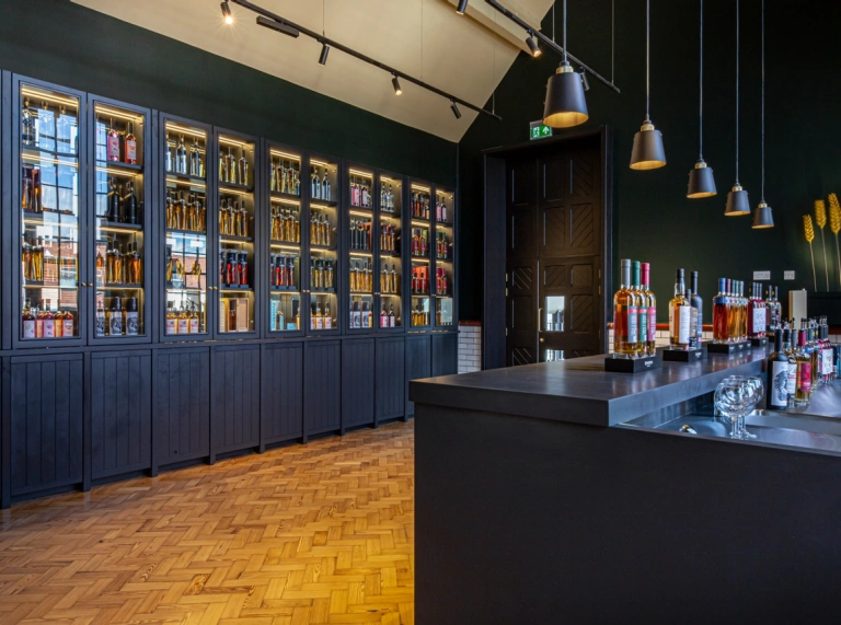 Inside Penderyn Distillery with bottles of whiskey on shelves.