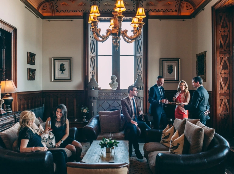 Group of people having drinks in a room.