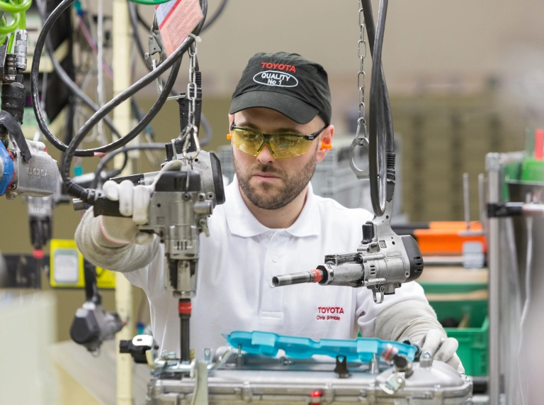 Toyota employee working on machinery