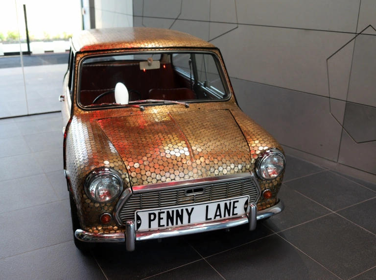 Mini car covered in coins at The Royal Mint Experience.