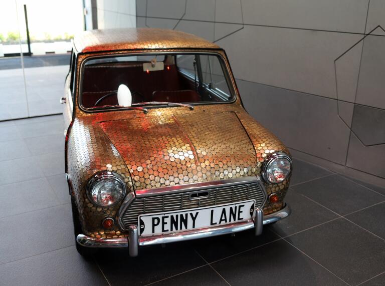 Mini car covered in coins at The Royal Mint Experience.