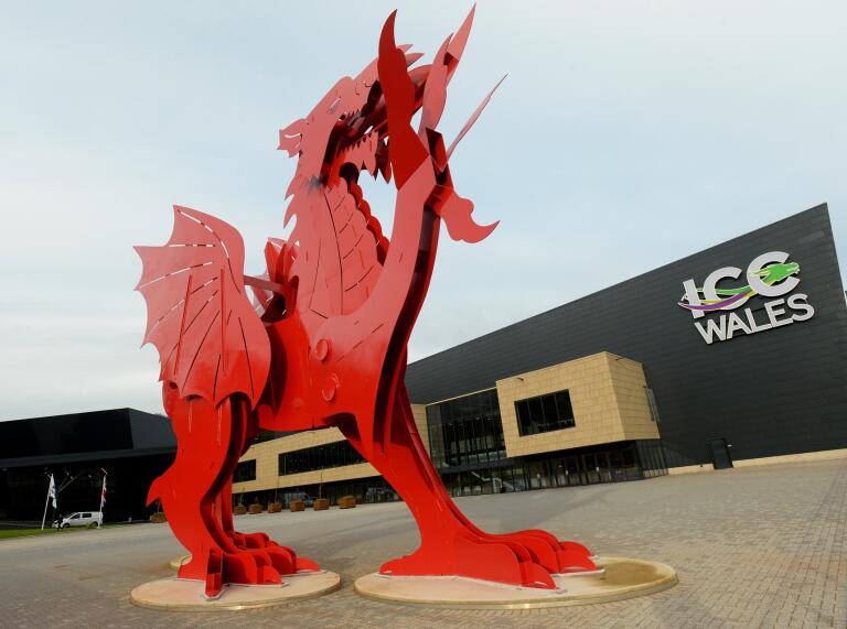 A large dragon sculpture outside an events and conference centre.