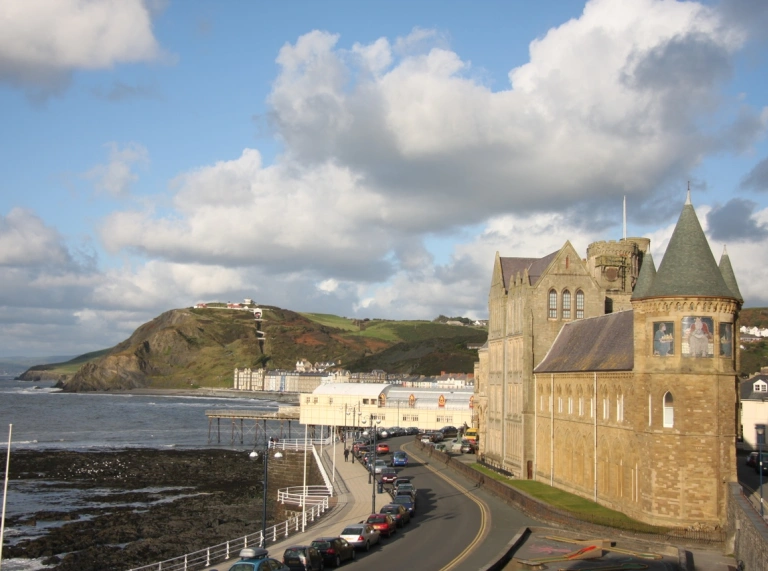 Mountains with sea and building in background
