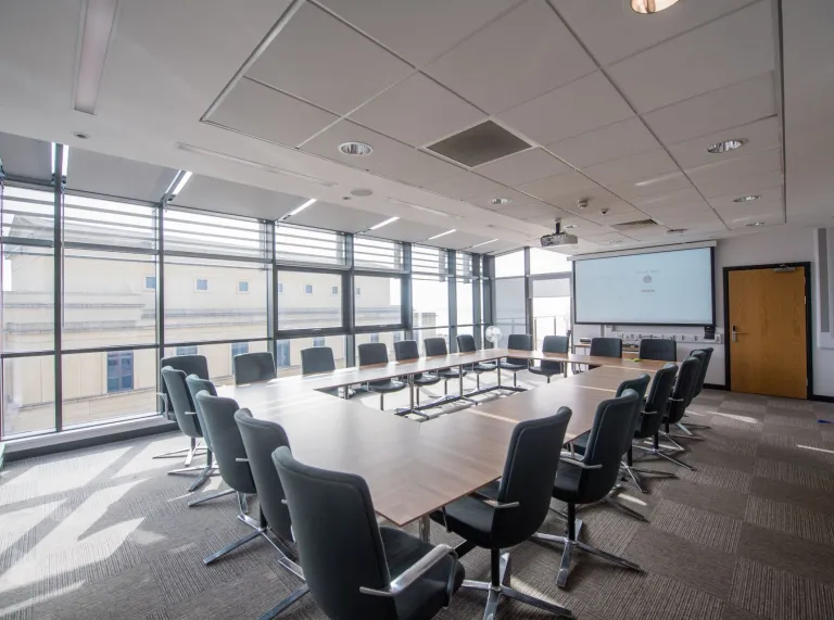 Swansea Universit bay meeting room with tables and chairs set out board room style