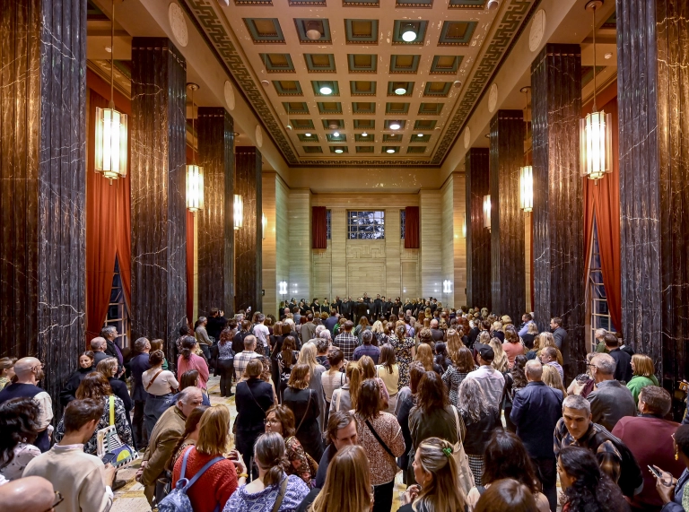 people congregated in the museum foyer  