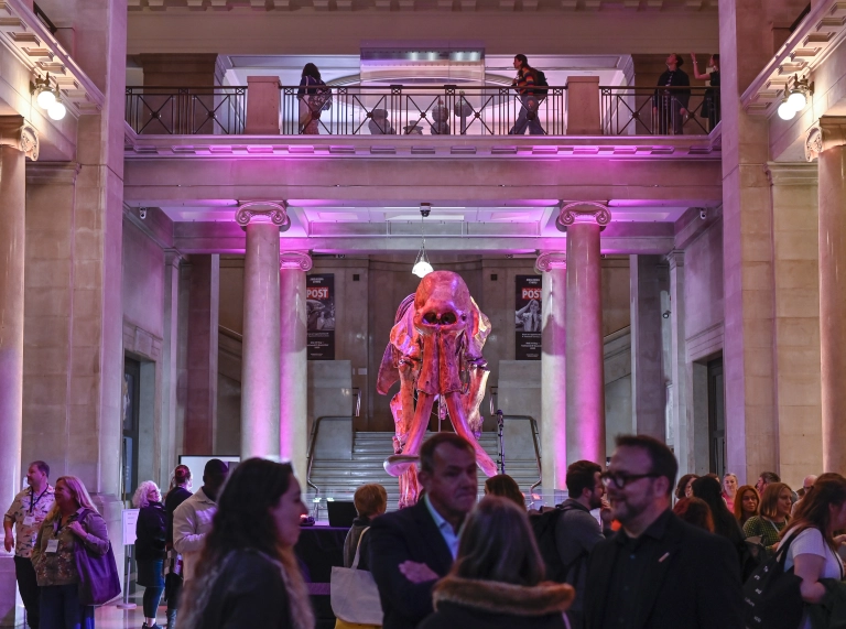 people congregated in the museum foyer   