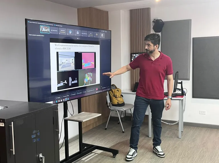 Researcher presenting work on mobile robot navigation