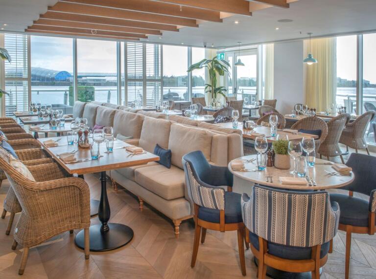 A dining room with views from double aspect windows toward the Bay.
