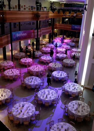 Tables set up in the Wales Millennium Centre for a gala dinner.