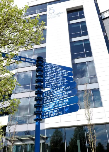 Visitor signposts outside a building.