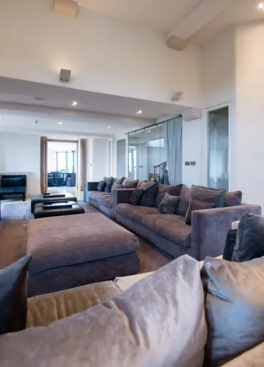 A lounging area with luxury sofas in a hotel.
