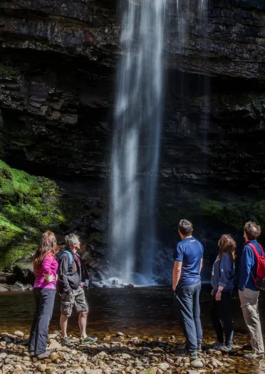 People looking at a waterfall.