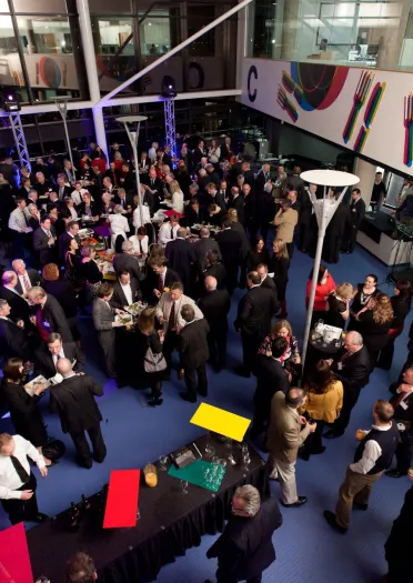 An overhead shot of lots of business people in a food court at a university.