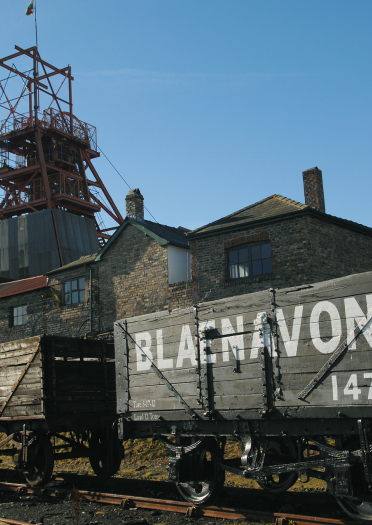 Wagons and the pit head tower at a mining attraction.