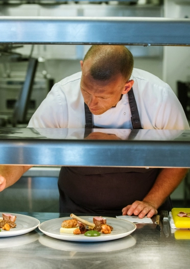 Chef plating up food.