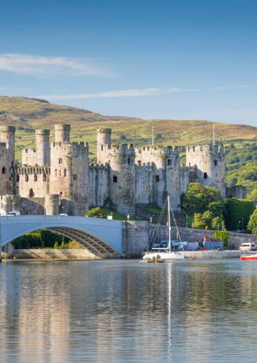Conwy Castle against the mountains and quay 