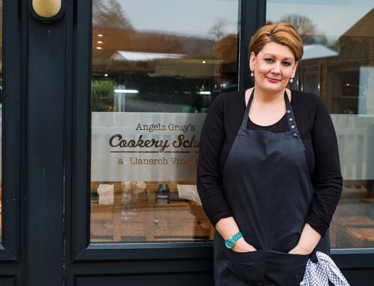 Angela Gray standing outside her cookery school.