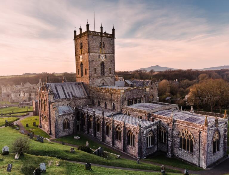 A magnificent view of the entire St Davids Cathedral during sunset.