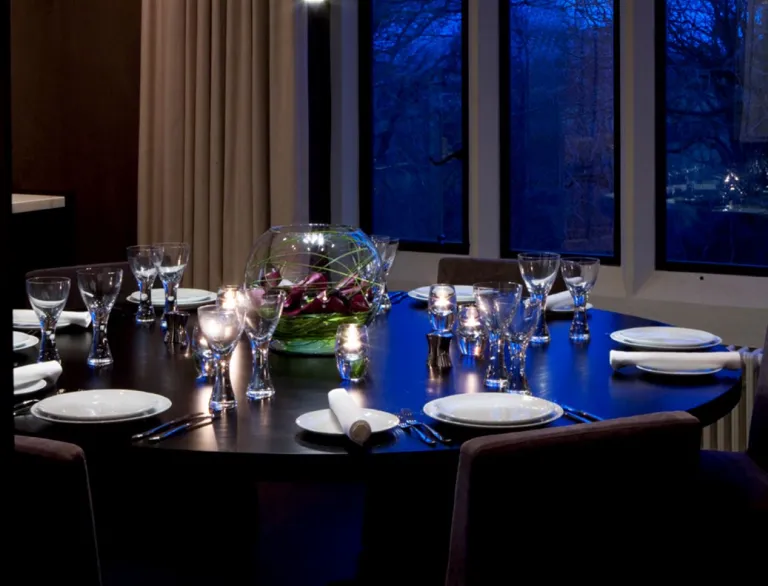 Dining table set up with candles.