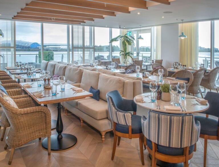 A dining room with views from double aspect windows toward the Bay.