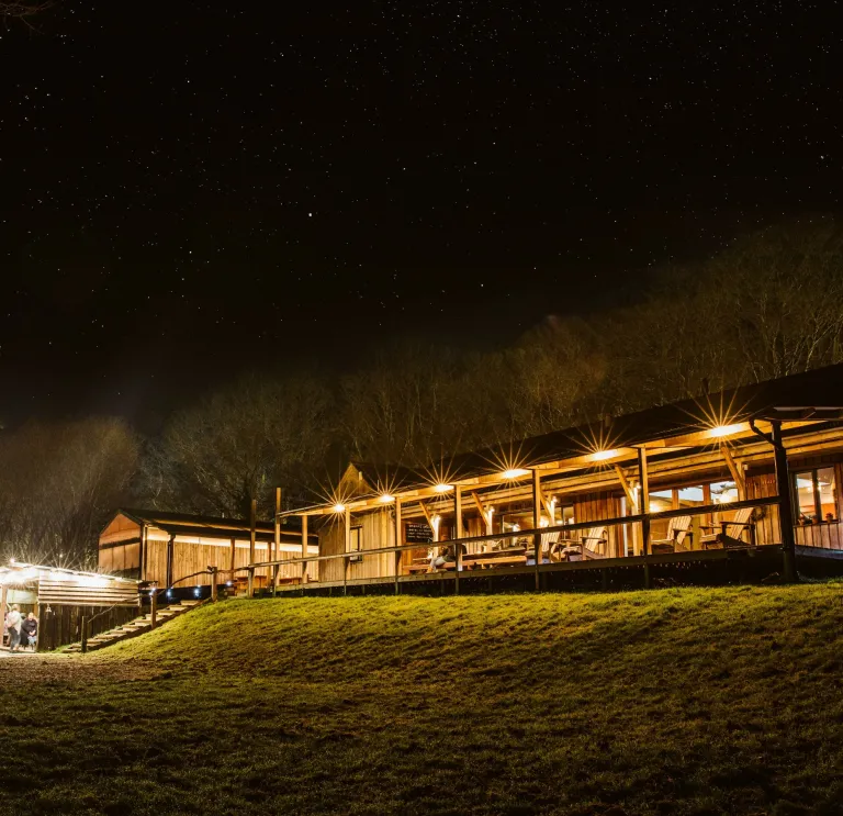 Outside the buildings of Fforest accommodation at night.